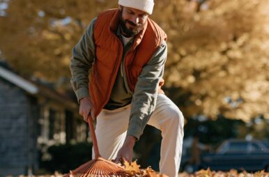 man raking leaves