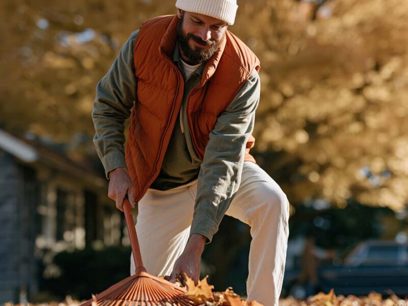 man raking leaves